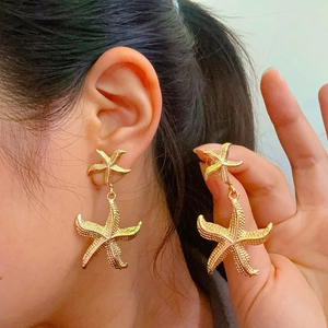 Elegant gold starfish drop earrings with a vintage textured finish for a chic summer look