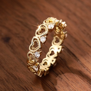 Detailed view of hollow heart eternity ring with gold finish and sparkling zircons