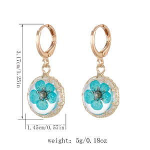 Detail view of glass ball earrings with blue dried flowers and measurement annotations