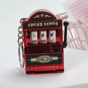 Detailed close-up of a red mini lucky slot machine keychain with a metallic finish