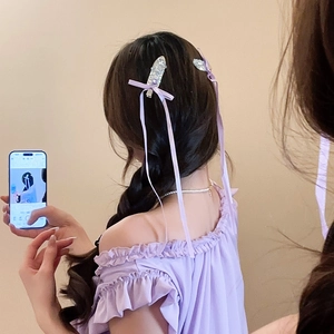 Detailed view of light purple ribbon bow hair clip with sparkling rhinestones and long tassels