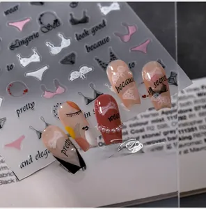 Detailed 5D nail art stickers with lingerie silhouettes and patterns on long nails