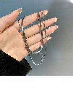 Close-up of double-layer silver snake chain and link necklace with adjustable extension