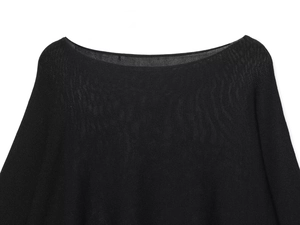Detail of boat neckline and fine knit texture on this black minimalist batwing sleeve sweater
