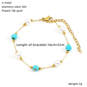 Detail of 18K gold plated stainless steel bracelet with pearls and blue glass beads