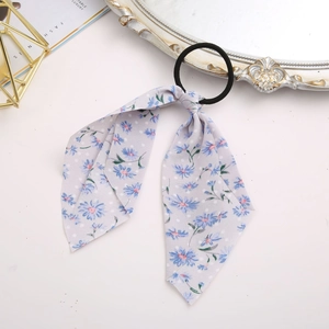Detail of light purple floral chiffon scrunchie with long ribbons and elastic hair tie