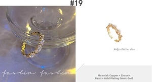 Close-up detail of wave-shaped golden ring with elegant pearls and sparkling zircons