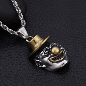 Detailed macro view of a two-tone stainless steel hip-hop clown pendant on a twist chain