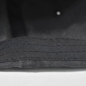 Detail of multi-row stitching on black washed baseball cap brim with durable finish