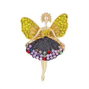 Vintage fairy brooch with golden wings and colorful rhinestones on a white background