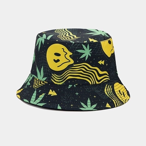 Detailed close-up of double-sided bucket hat with green leaf and wavy smiley patterns
