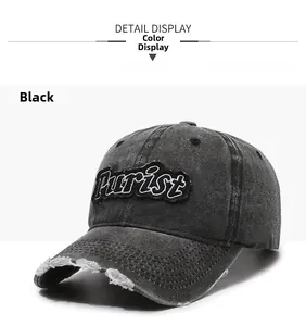 Detailed shot of distressed brim and Purist embroidery on washed black cotton baseball cap