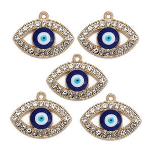 Detailed view of five golden evil eye pendants with sparkling white zircons and blue resin