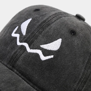 Washed dark grey baseball cap with white pumpkin skull embroidery for Halloween