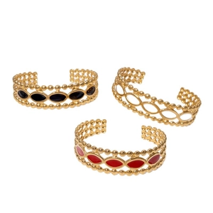 Ensemble de trois bracelets ouverts en acier plaqué or 18k avec émail rouge et noir