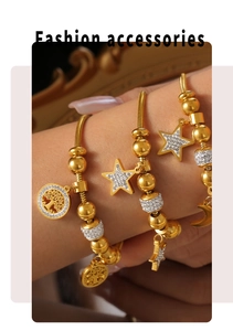 Detail of three gold star moon tree of life bracelets with pavé rhinestones on wrist