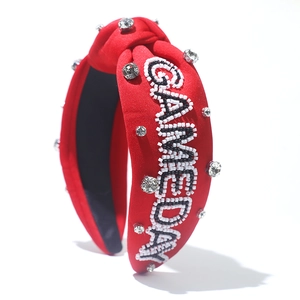 Close-up of red knotted headband with GAMEDAY beadwork and sparkling rhinestones