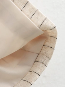 Detail of pinstripe vest showing linen texture and smooth satin lining stitching