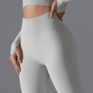 Detail view of light grey ribbed high waist yoga pants and thumbhole long sleeve top