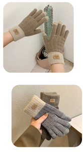 Detail of knitted winter gloves with thick fleece lining and leather brand label