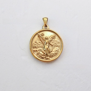 Macro detail of 18K gold plated coin pendant featuring the iconic winged victory relief