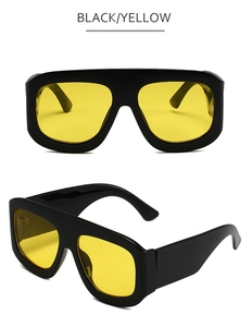 Detail of square oversized black sunglasses with yellow lenses from front and side view