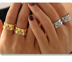Detail shot of heart shaped rings in gold and silver finish with sparkling rhinestones