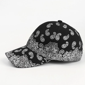 Detailed view of the vintage black and white paisley pattern on a classic cotton baseball cap