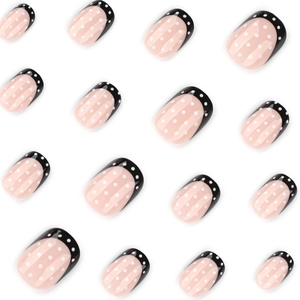 French style short square press-on nails in black with white polka dot patterns