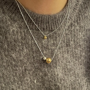 Minimalist 925 sterling silver layered necklace with gold and silver beads on a sweater
