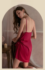 Detailed back view of sleek wine red satin slip dress with elegant drapery