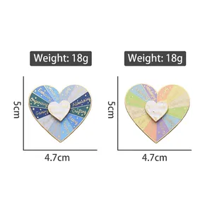 Rotating heart self-care enamel pin showing colorful options and size dimensions