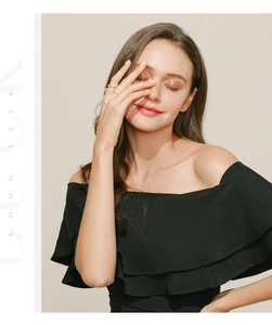 Detail of minimalist 925 sterling silver ring worn with black off-shoulder pleated dress