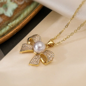 Elegant 18K gold plated bow necklace with sparkling zircon pavé and white pearl pendant