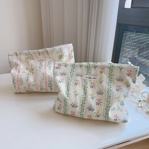 Detail of floral cotton pouches with zipper and simple wish label in a pastoral style