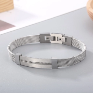 Detailed macro view of silver stainless steel mesh bracelet with brushed rectangular plate