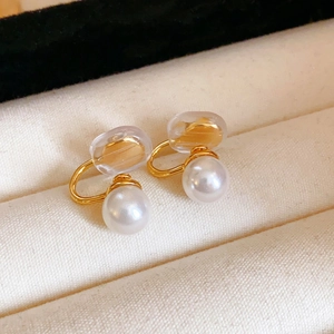 Detail of gold pearl ear clips for non-pierced ears with comfortable silicone pads