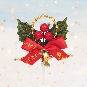 Christmas cake topper featuring red berries, green holly leaves, and a golden bell decor