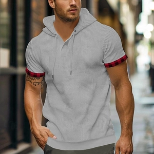 Detail of grey waffle knit hooded t-shirt with red and black plaid trim on sleeve cuffs