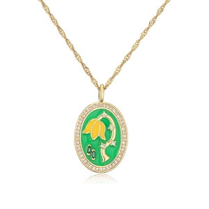 Detailed close-up of a gold necklace with green enamel pendant and yellow flower inlay