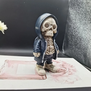Detail of skeleton alien figurine in blue hoodie and jeans for home garden decor