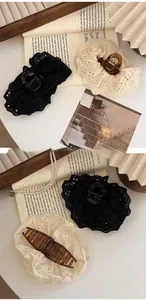 Detail of French lace embroidery hair claw clips in elegant beige and black floral styles