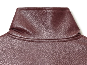 Detail of burgundy faux leather jacket showing stand collar and pebble grain texture