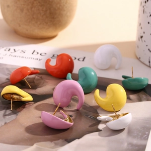 Detailed close-up of macaron enamel stud earrings in organic fluid comma shapes
