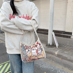 Close-up of white canvas tote featuring cute Christmas puppy and tree cartoon prints
