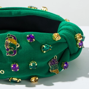 Detail of green knit Mardi Gras headband featuring colorful rhinestones and gold charms