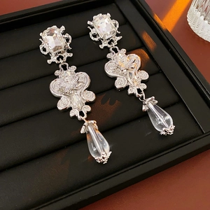 Baroque resin crystal flower drop earrings with silver pins on black velvet display