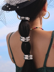 Silver stainless steel semi-circle hair cuff accessory shown on a braided ponytail