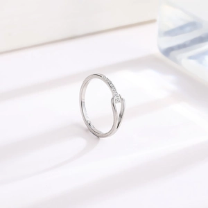 Close-up of a silver titanium steel ring featuring a sleek cutout design and cubic zirconia