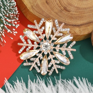 Exquisite snowflake brooch with champagne crystals and diamonds on a festive background